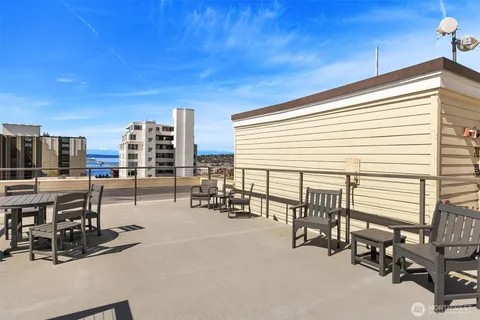 a view of a patio with dining table and chairs with wooden floor and fence