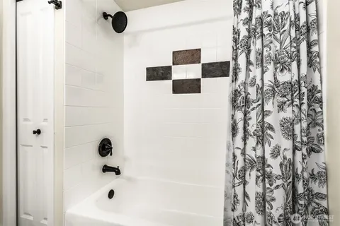 a bathroom with a bathtub and a shower