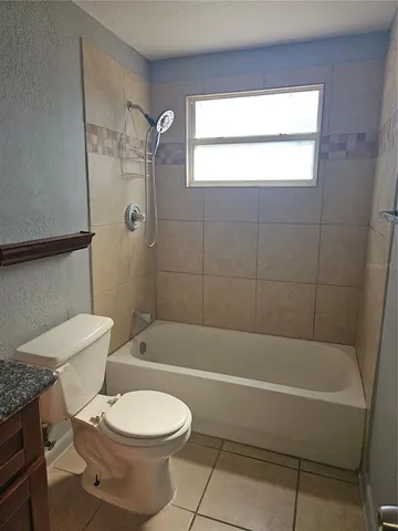 a bathroom with a toilet and a bath tub