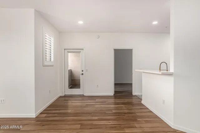 a view of a hallway with wooden floor