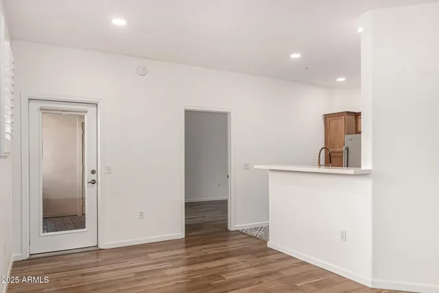a kitchen with stainless steel appliances granite countertop a sink and a refrigerator