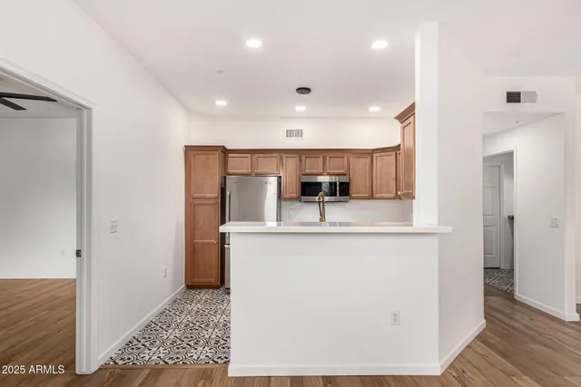 a kitchen with stainless steel appliances a refrigerator stove and microwave