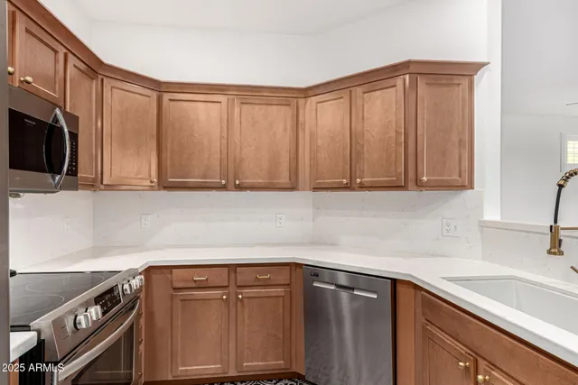 a kitchen with a sink cabinets and window