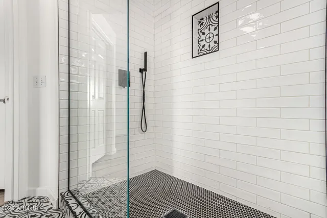 a bathroom with a double vanity sink a mirror and shower