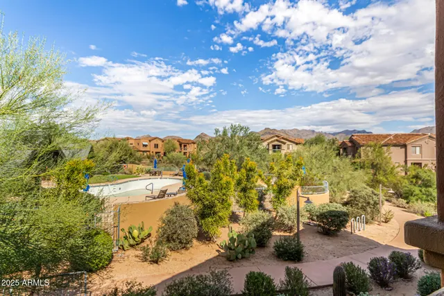 a view of a patio with table and chairs and potted plants