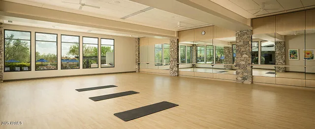 a living room with furniture a fireplace and a floor to ceiling window