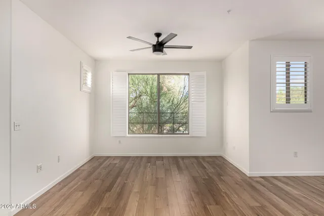 a view of a hallway with wooden floor and closet