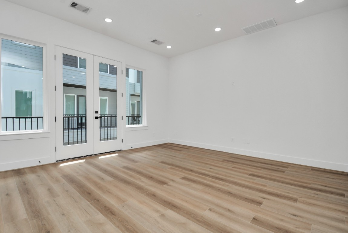 3036 Live Oak Street Houston, TX 77004 - Photo 11 of 35 an empty room with wooden floor and windows
