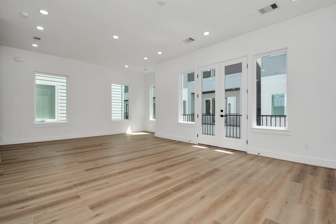 3036 Live Oak Street Houston, TX 77004 - Photo 12 of 35 a view of an empty room with wooden floor and a window