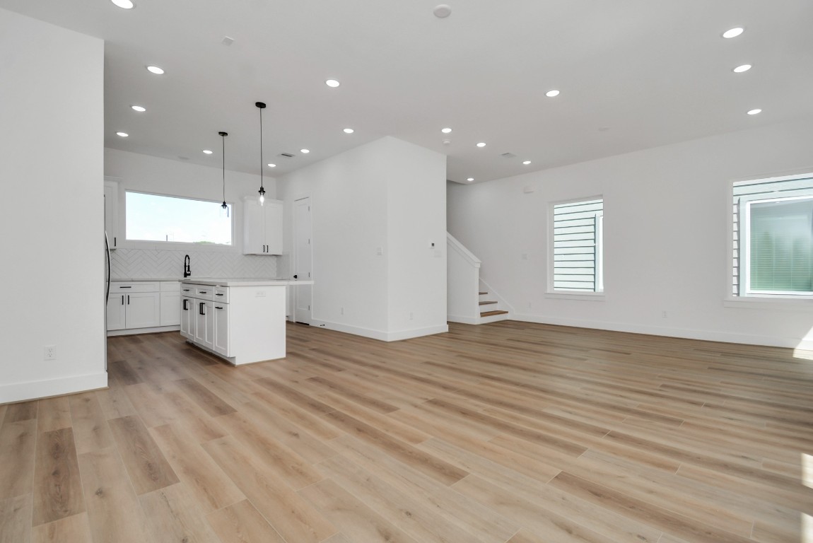3036 Live Oak Street Houston, TX 77004 - Photo 13 of 35 a view of kitchen with white cabinets and wooden floor