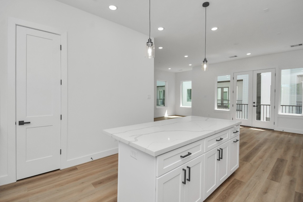 3036 Live Oak Street Houston, TX 77004 - Photo 18 of 35 a kitchen with a sink chandelier and wooden floor