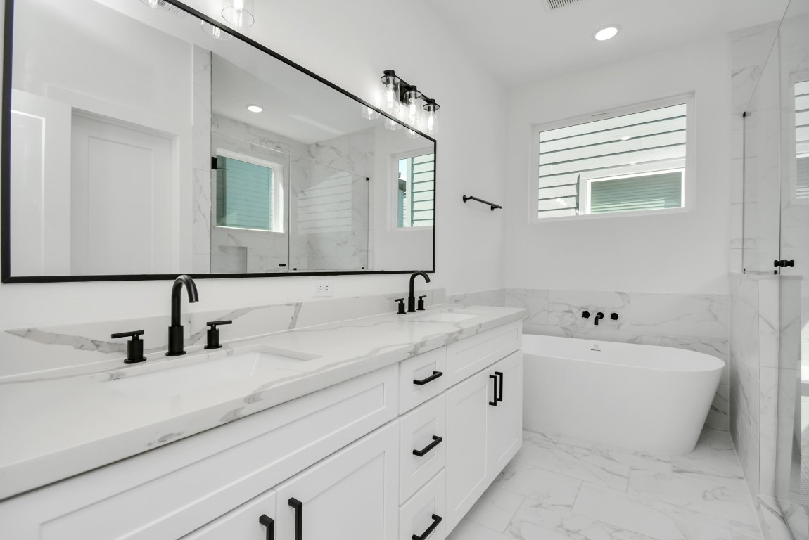 3036 Live Oak Street Houston, TX 77004 - Photo 24 of 35 a bathroom with a double vanity sink mirror and bathtub