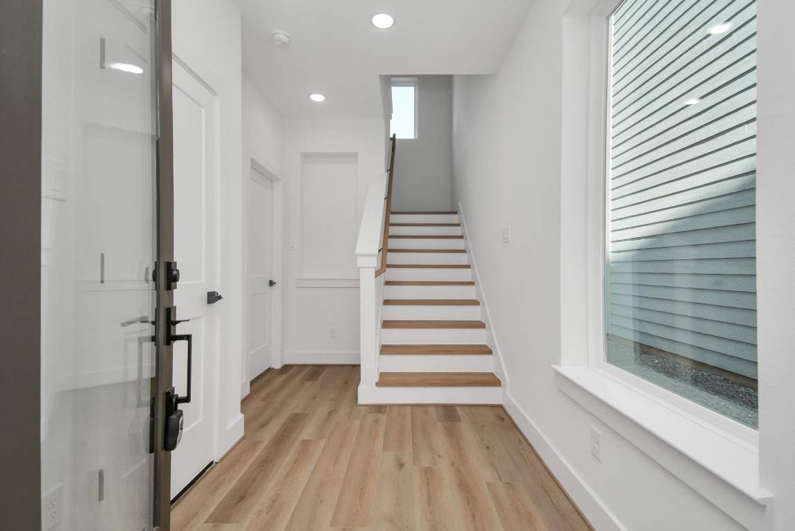 3036 Live Oak Street Houston, TX 77004 - Photo 3 of 35 a view of a hallway with wooden floor and staircase