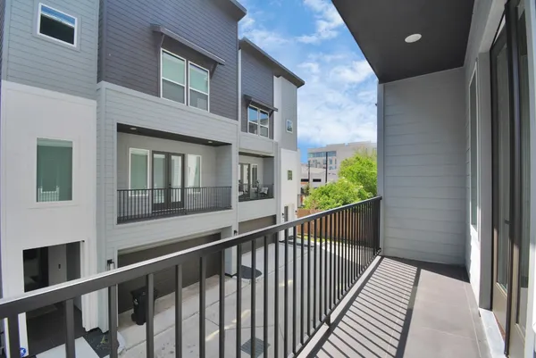 a view of balcony with wooden floor and fence