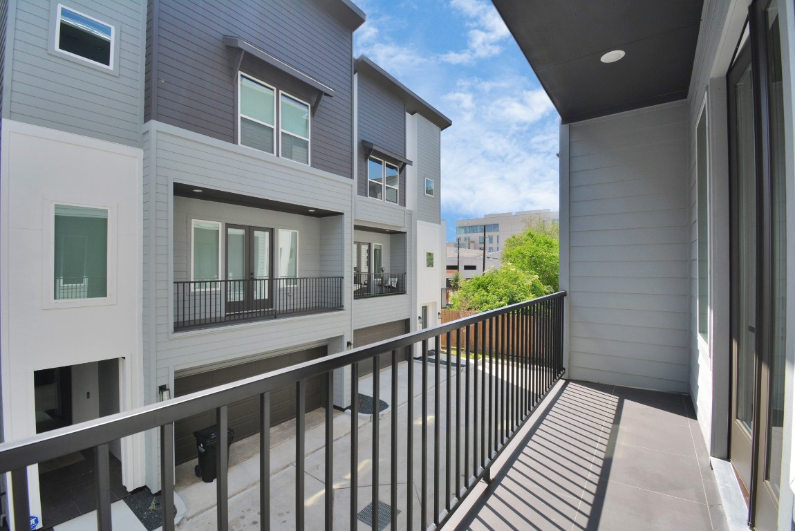 3036 Live Oak Street Houston, TX 77004 - Photo 33 of 35 a view of balcony with wooden floor and fence