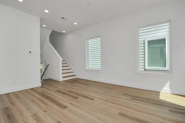 a view of an entryway with wooden floor and stairs