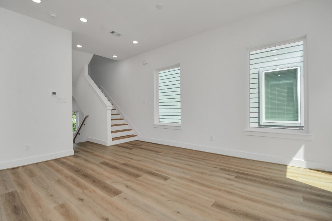 3036 Live Oak Street Houston, TX 77004 - Photo 8 of 35 a view of an entryway with wooden floor and stairs