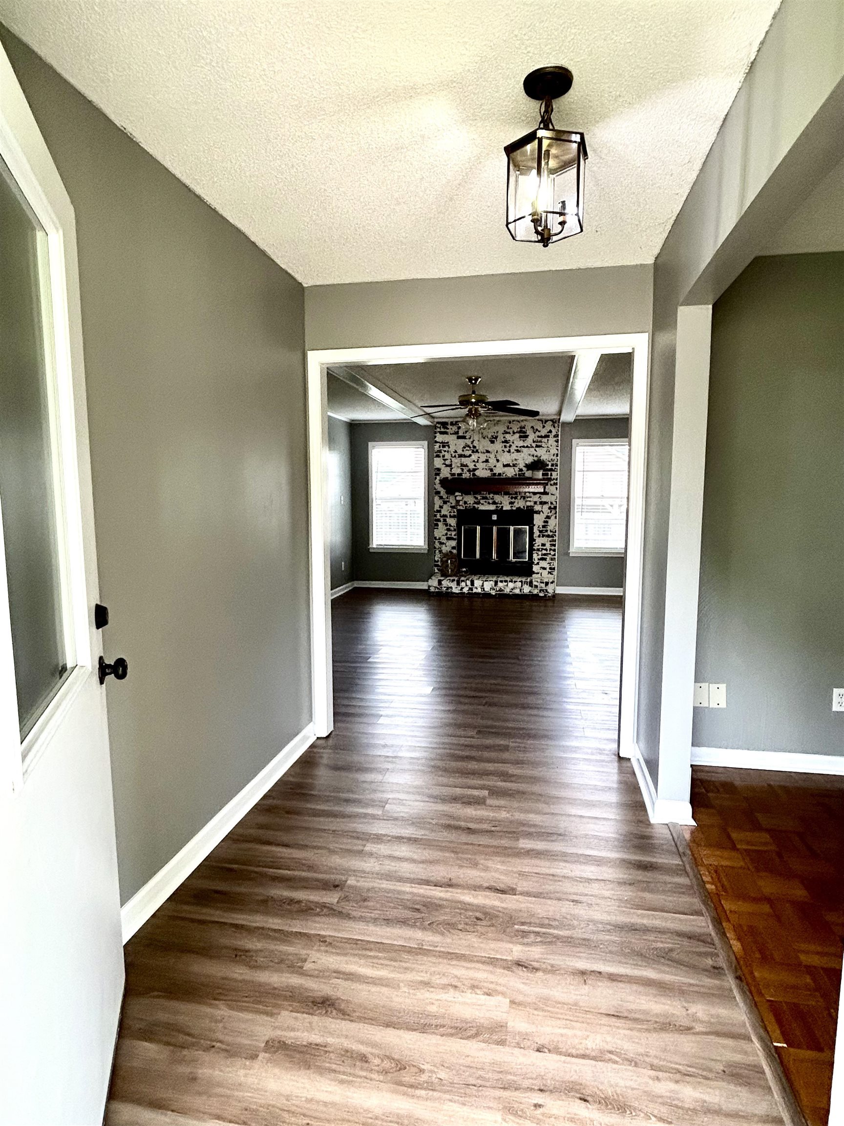 3257 Altruria Road Bartlett, TN 38134 - Photo 4 of 27 Corridor with a textured ceiling, wood finished floors, and baseboards