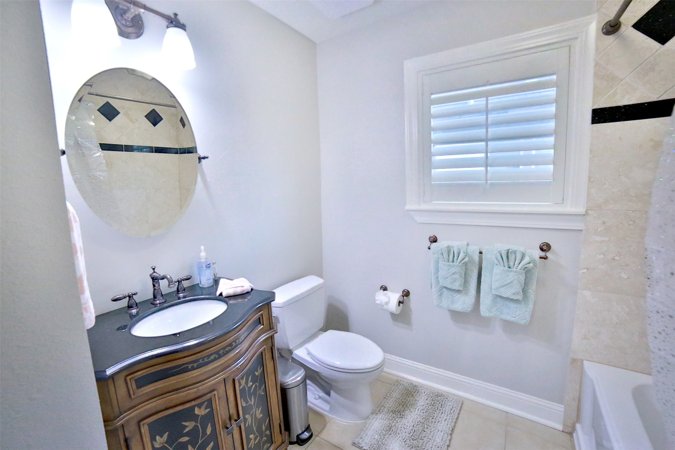 2625 Peckham Street Houston, TX 77098 - Photo 11 of 27 a bathroom with a toilet a sink and mirror