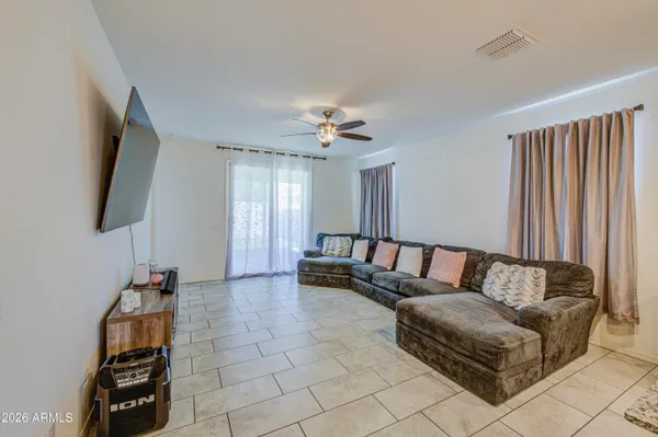 a living room with furniture and a flat screen tv