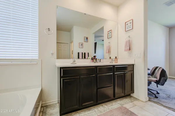 a bathroom with a sink vanity and a mirror