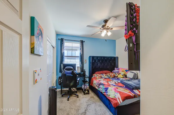 a bedroom with a bed and a chandelier