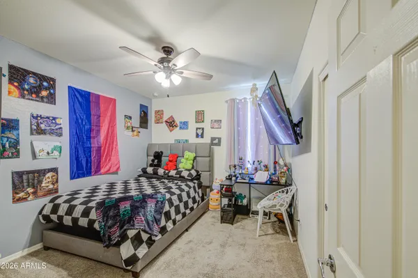 a bedroom with a bed and a chandelier