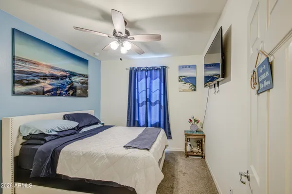 a bedroom with a large bed and a chandelier