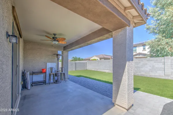 a view of a porch with furniture and a yard