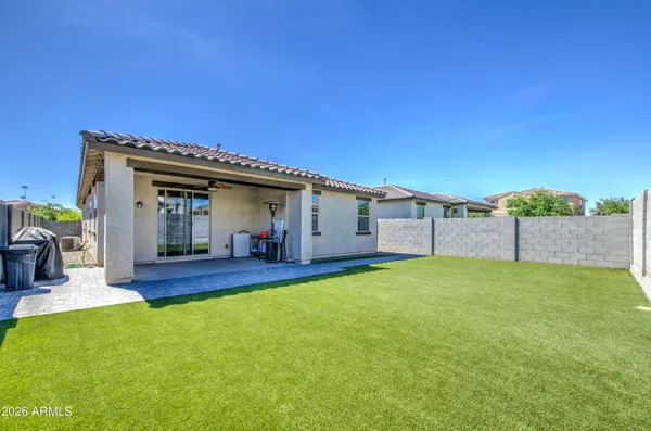 a view of a house with a yard and patio