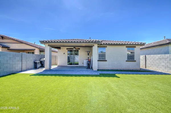a view of a house with a yard and sitting area