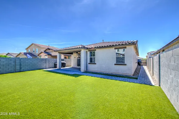 a view of a house with backyard and sitting area