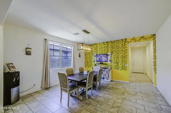 a view of a dining room with furniture and a window