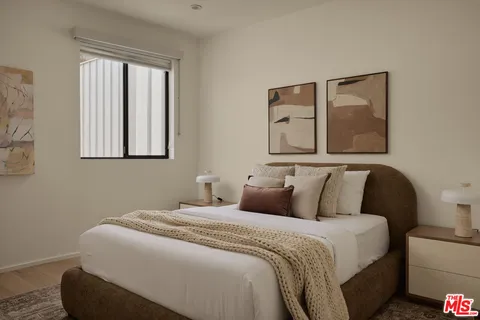 a bedroom with a bed and a painting on the wall