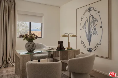 a living room with furniture and flowers