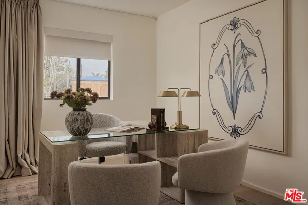 a living room with furniture and flowers