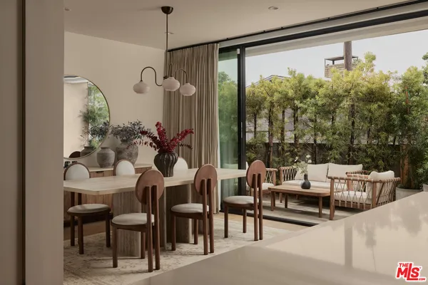 a dining room with furniture and a floor to ceiling window