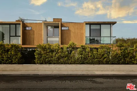 a front view of a house with lots of garden