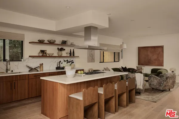 a kitchen with stainless steel appliances a sink stove and cabinets
