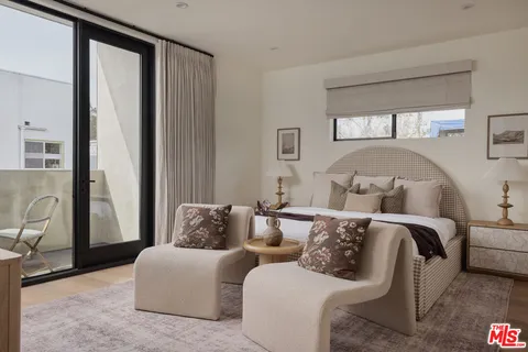 a living room with a large bed and a couch