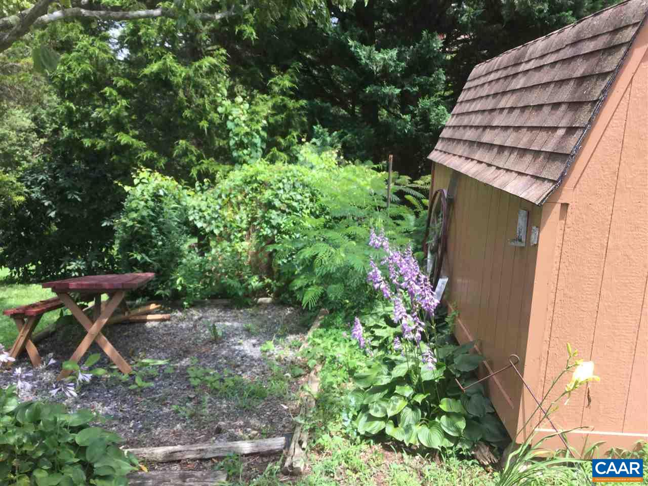 374 Pine Bluff Road Ruckersville, VA 22968 - Photo 14 of 24 a backyard of a house with table and chairs