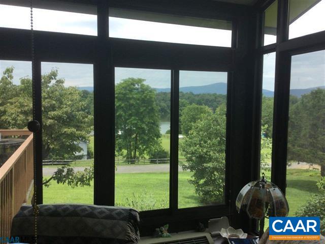 374 Pine Bluff Road Ruckersville, VA 22968 - Photo 3 of 24 a living room filled with furniture and a floor to ceiling window