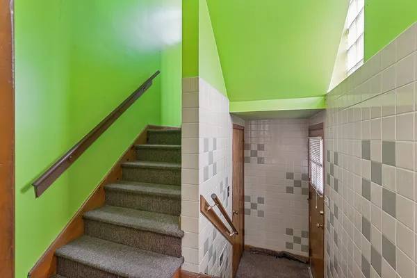 a backyard of a house with a barn table and chairs with wooden floor