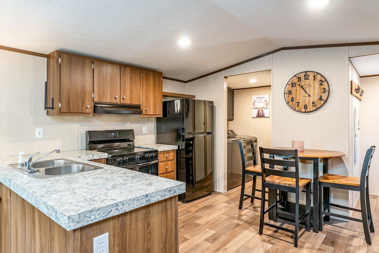 24 Co Rte 10/2 Franklin, WV 26807 - Photo 20 of 66 a kitchen with a table chairs and a refrigerator