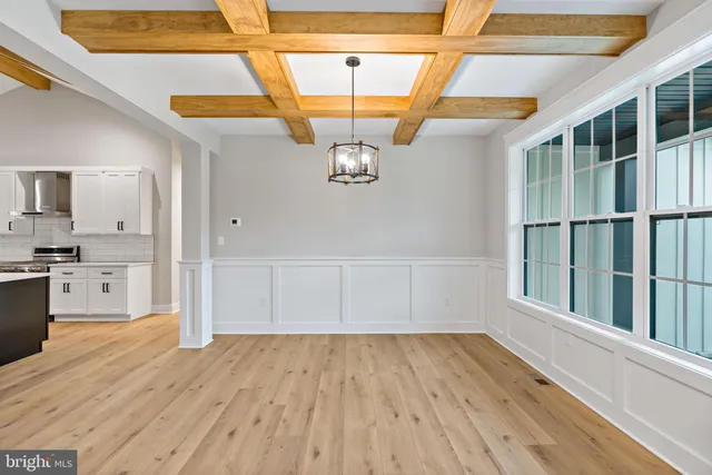 a view of empty room with wooden floor and cabinet