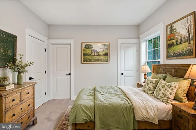 a bedroom with a bed a window and a potted plant