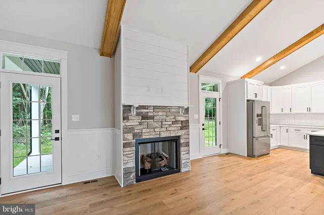 a view of a kitchen with a fireplace and a window