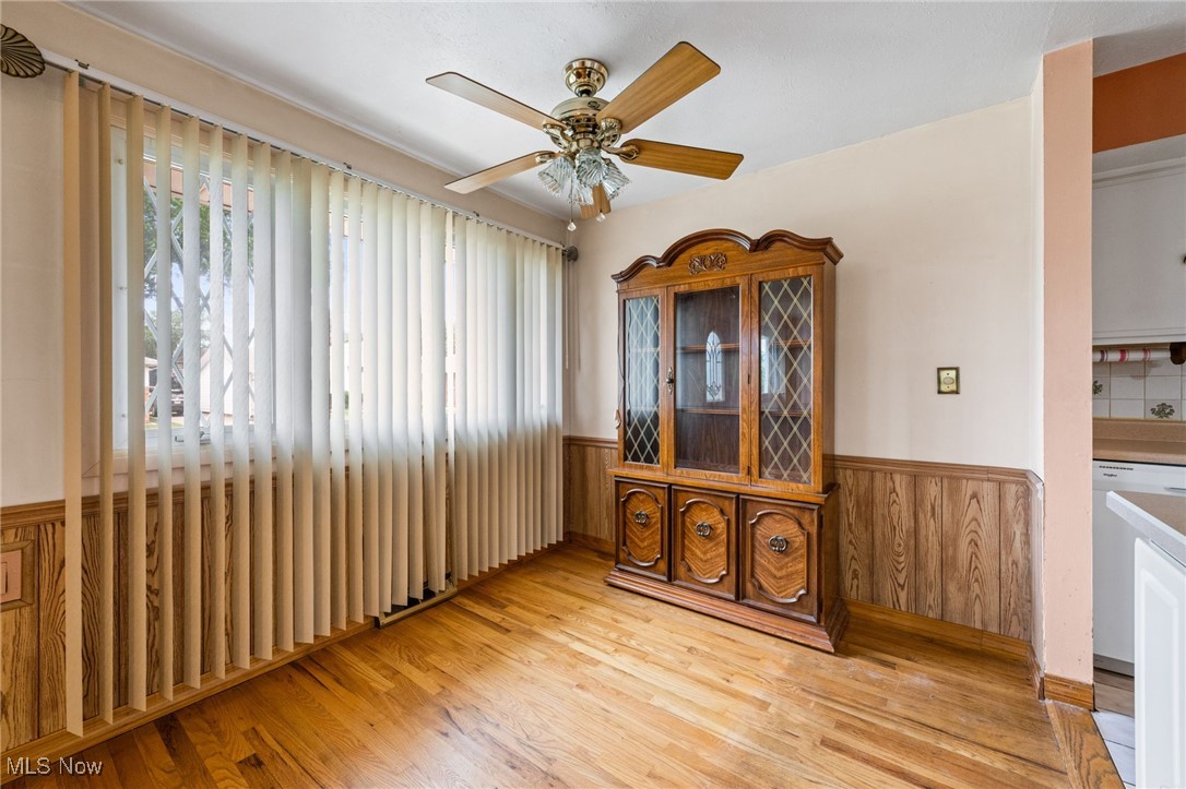 30844 Harrison Road Wickliffe, OH 44092 - Photo 5 of 30 Dining area featuring a wainscoted wall, light wood-style flooring, and a ceiling fan