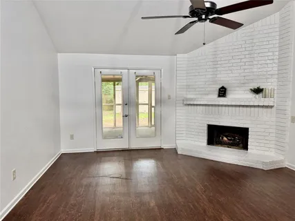 a view of an empty room with a fireplace and a window