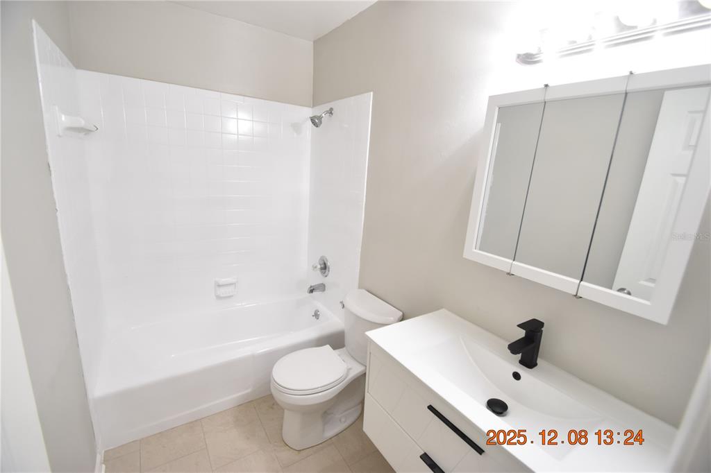 705 2nd Avenue Northwest, Unit B Ruskin, FL 33570 - Photo 18 of 29 a bathroom with a sink a toilet and shower